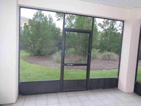 a view of the yard through a glass door