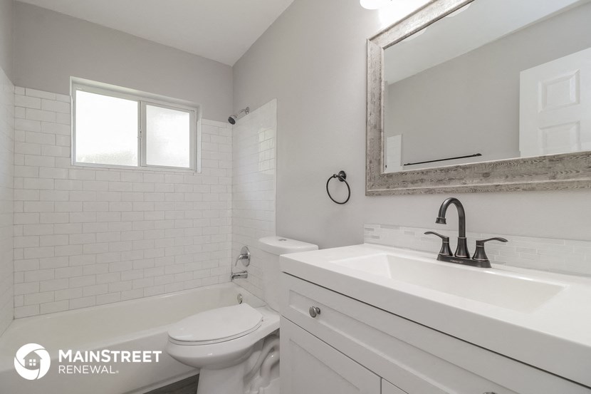 a white bathroom with a sink and a toilet
