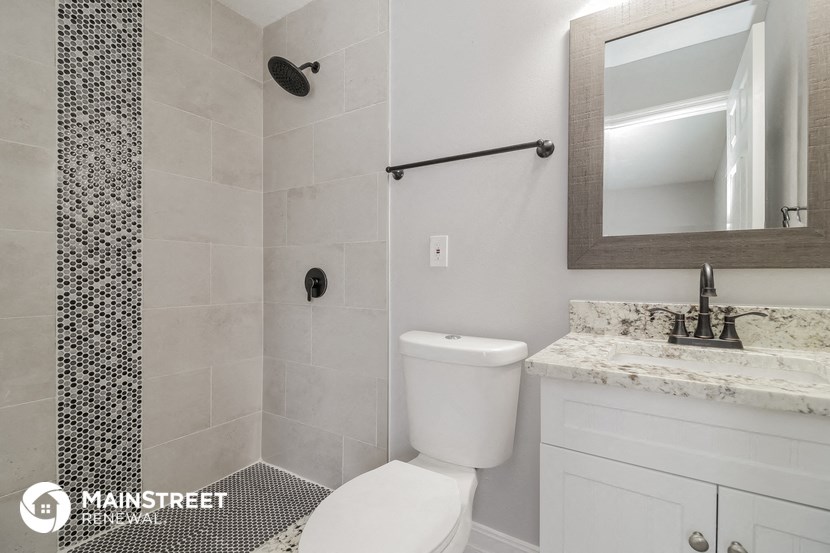 a small bathroom with a toilet and a sink and a shower