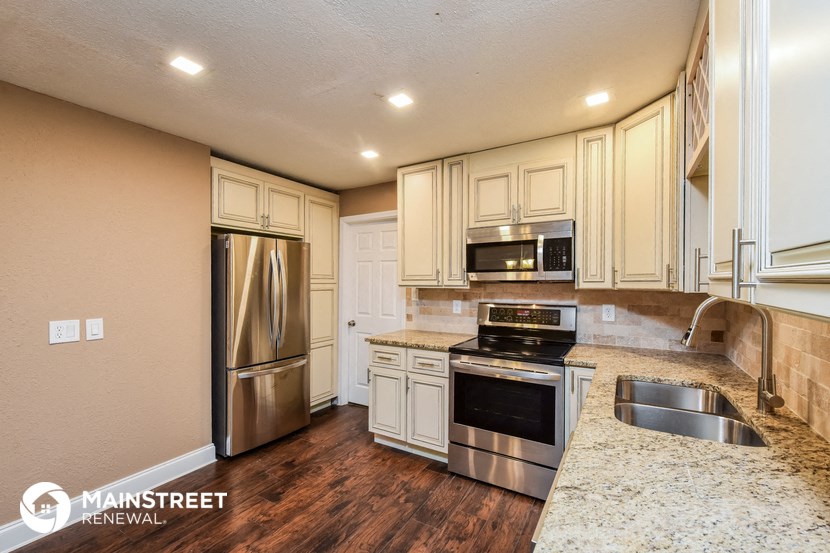 a kitchen with stainless steel appliances and granite counter tops