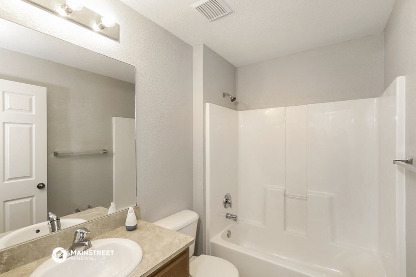 a bathroom with a sink and a shower and a toilet