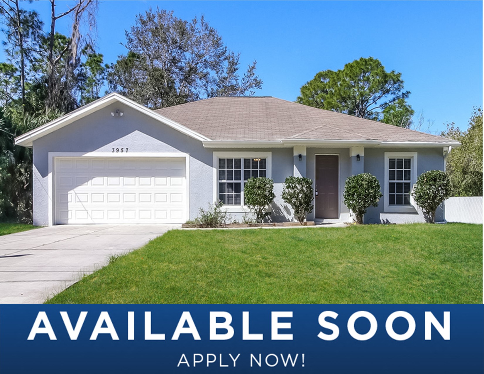 a small white house with a lawn and a garage