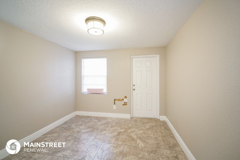 a empty room with a white door and a window