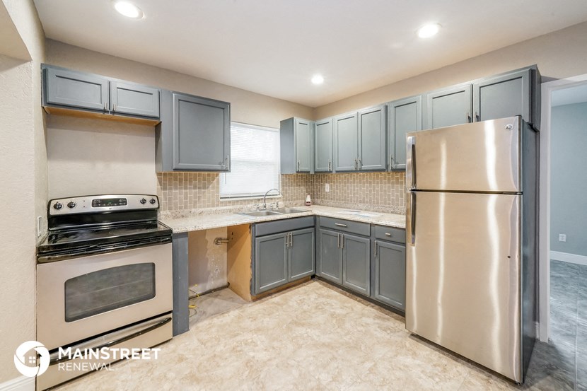 a kitchen with stainless steel appliances and blue cabinets