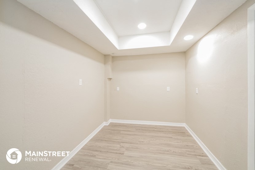 a empty room with white walls and a wooden floor