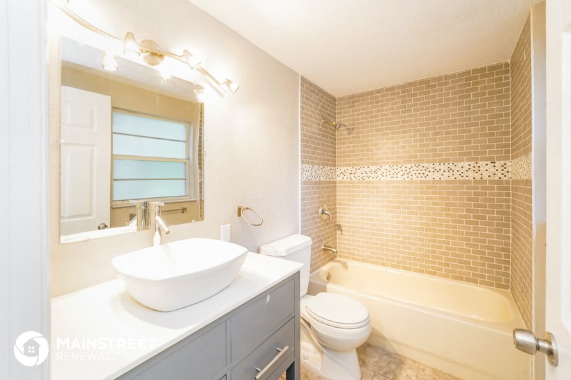 a bathroom with a sink and a tub and a toilet