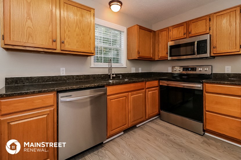 a kitchen with wooden cabinets and stainless steel appliances