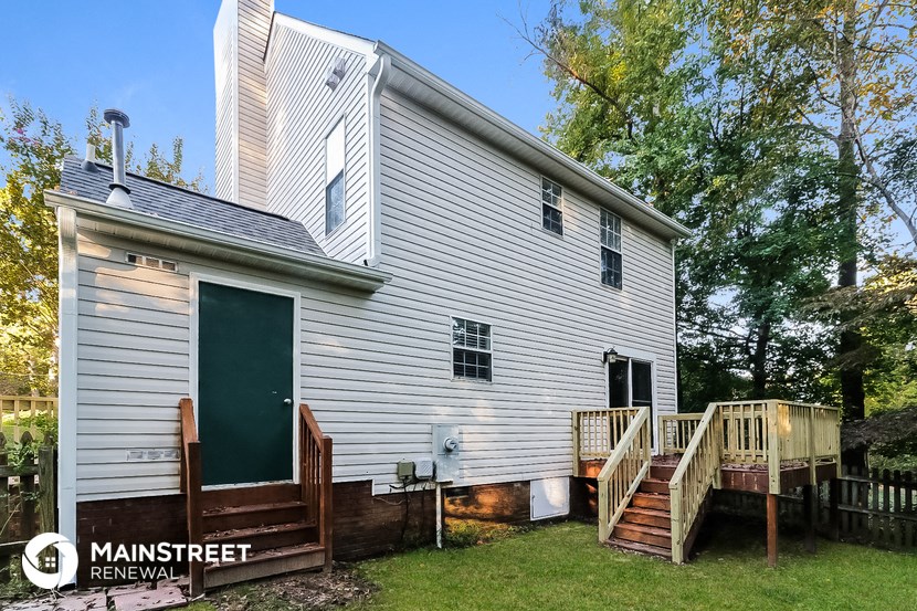 a white house with a porch and a deck