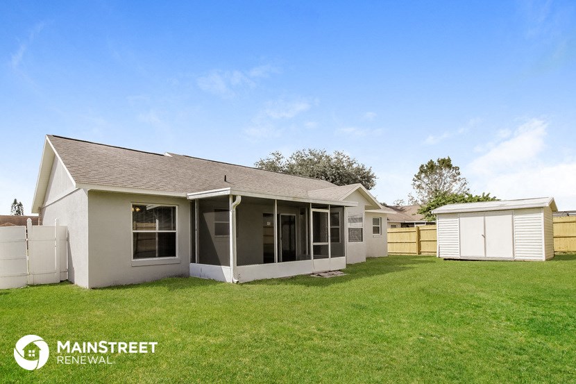 the exterior of a home with a yard and a garage