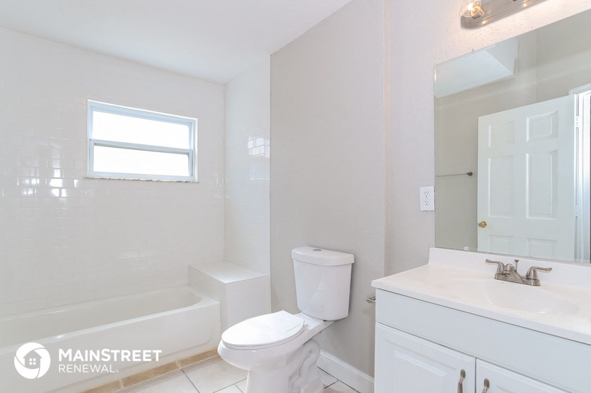 a bathroom with a toilet and a sink and a bath tub