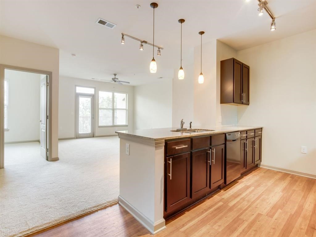 an empty kitchen and living room with a counter top
