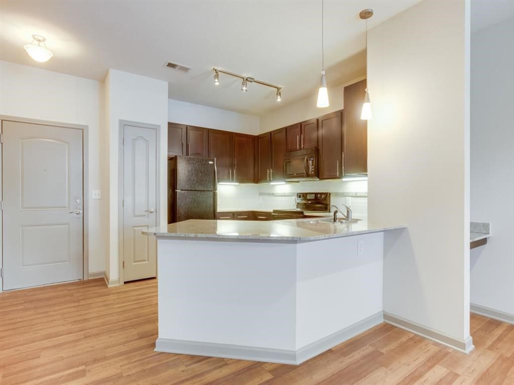 a kitchen with a counter top and a refrigerator
