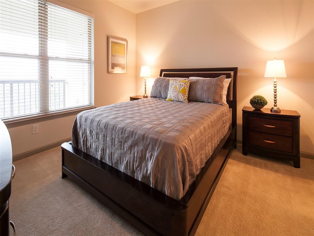 a bedroom with a bed and two night stands