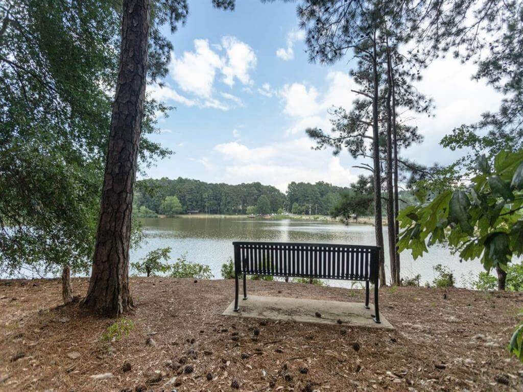 a park bench sitting next to a lake