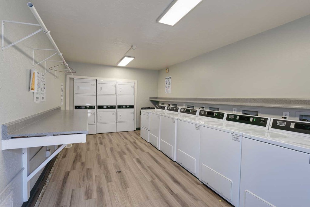the laundry room is equipped with washer and dryers and has a counter top