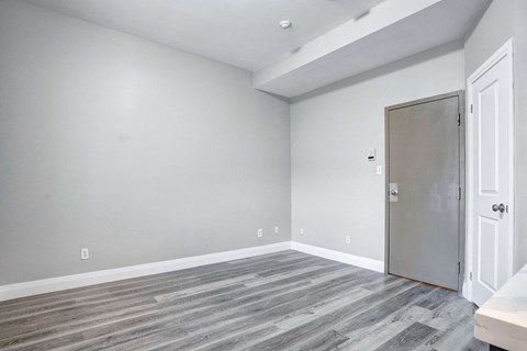 an empty room with grey walls and a door