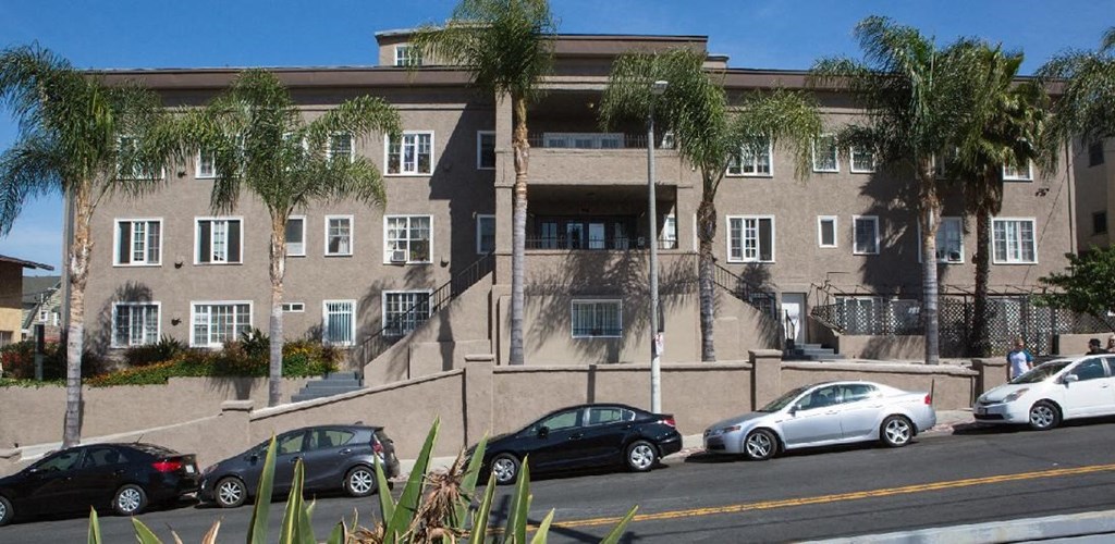 a large building with cars parked in front of it