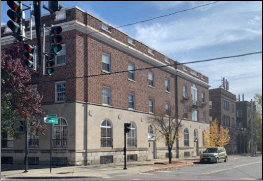 a building on the corner of a street with a traffic light