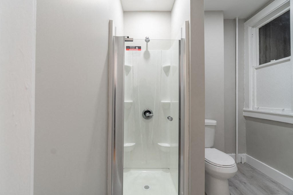 a small bathroom with a shower and a toilet