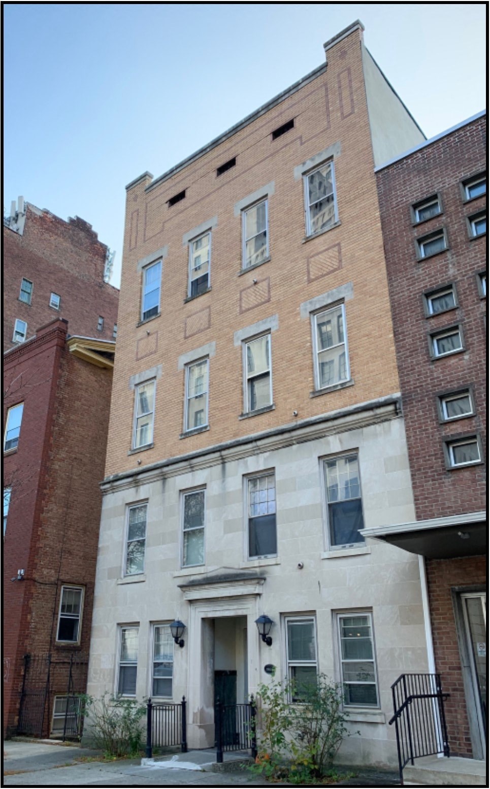 a large brick building with a white facade