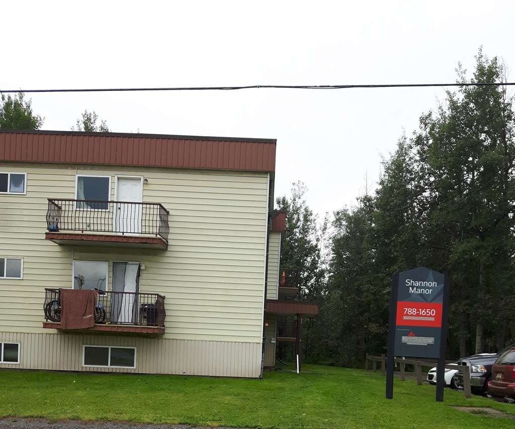 a white house with a red sign in front of it
