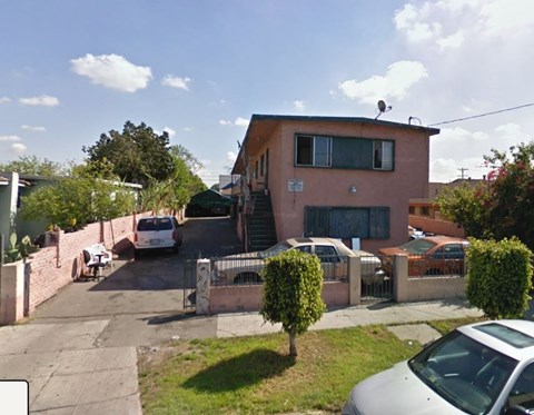 A house with a white car parked in front.
