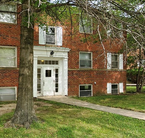 a brick building with a tree in front of it