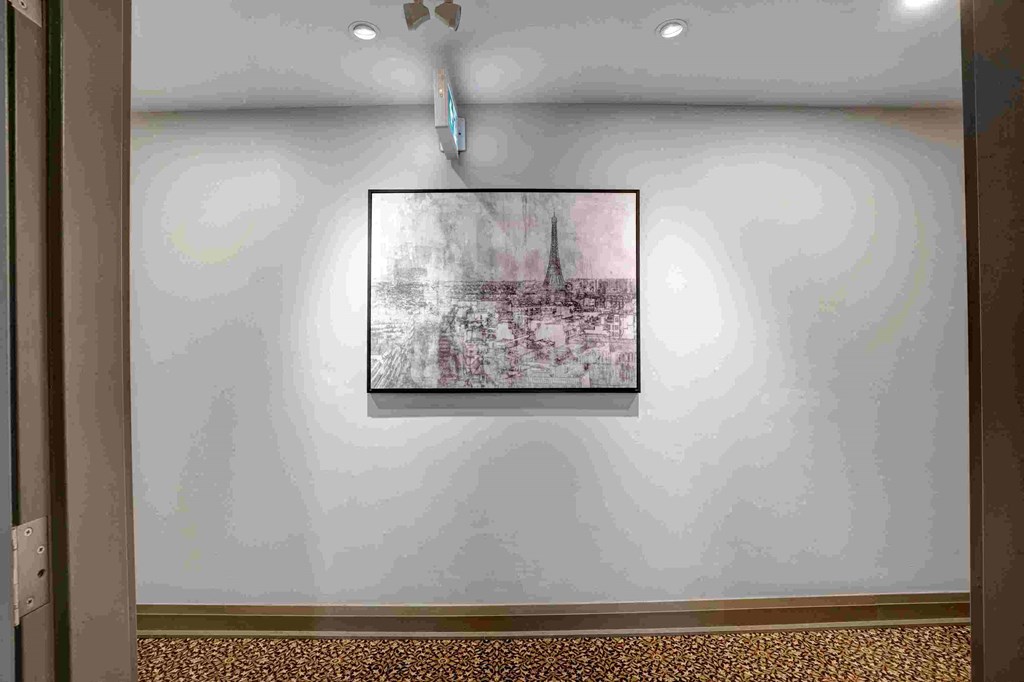 a painting hanging on a wall in a room