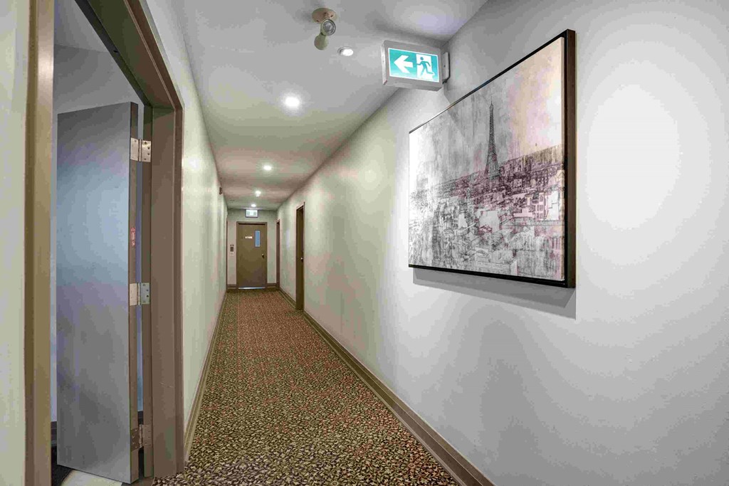 a hallway with a painting on the wall and a door
