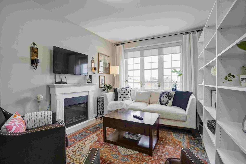 a living room with a white couch and a fireplace