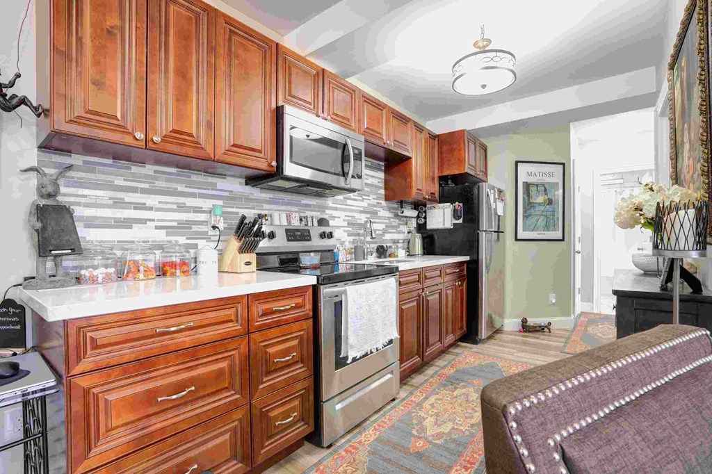 a kitchen with wooden cabinets and stainless steel appliances