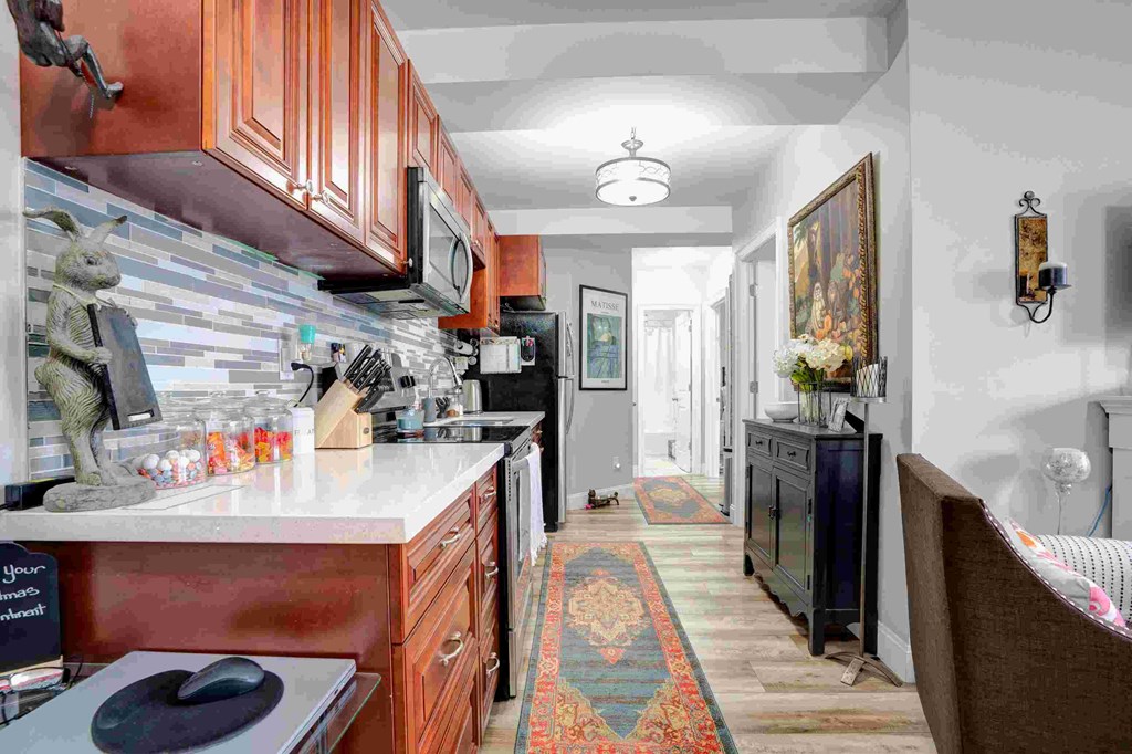 a kitchen with wooden cabinets and a counter top and a sink