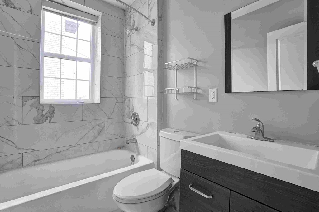 a bathroom with a sink and a toilet and a tub