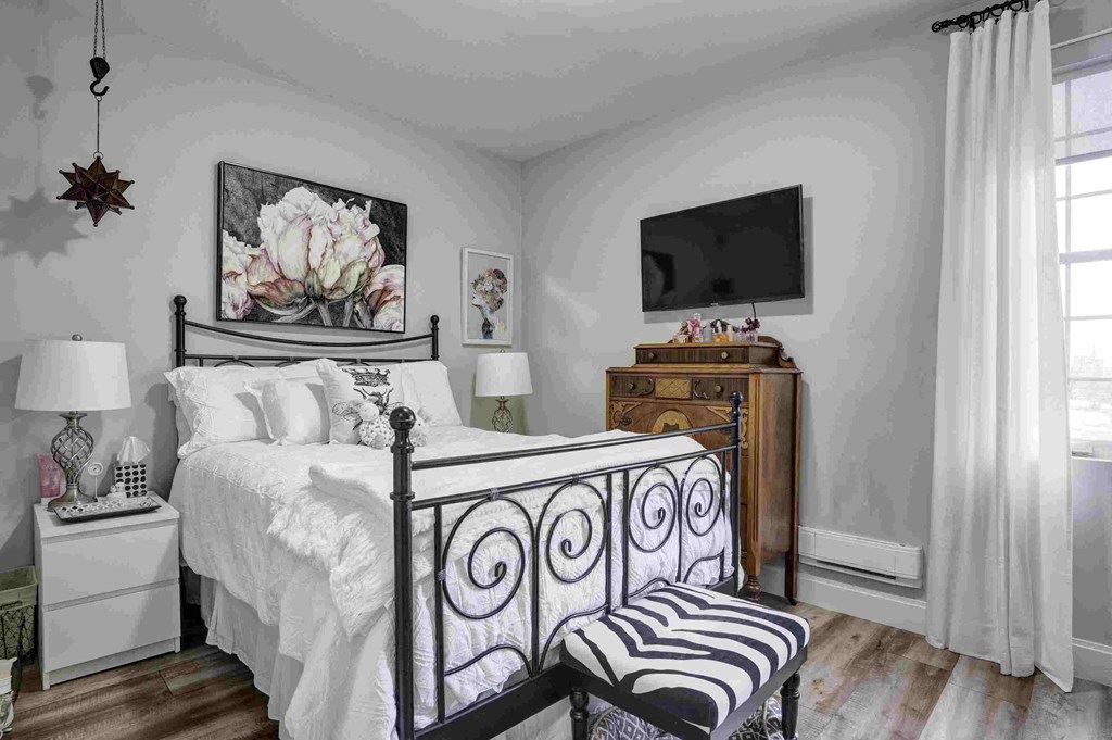 a bedroom with a bed and a tv in it