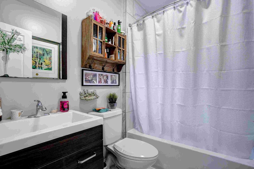 a bathroom with a sink toilet and a shower