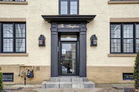 the facade of a building with a black door