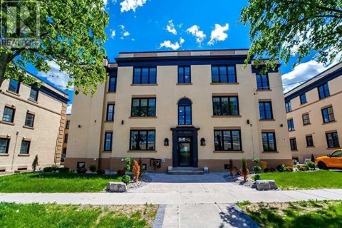 a large building with a sidewalk in front of it