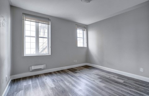 the living room of an empty house and wood floors