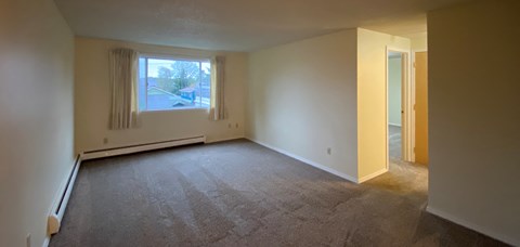 an empty living room with a large window
