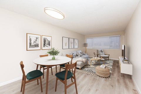 A living room with a white table and chairs.