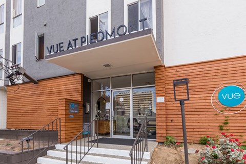 The entrance to a building with a sign that reads "Vue at Piedmont".