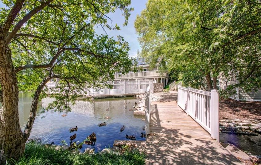 a bridge over a body of water with a building in the background