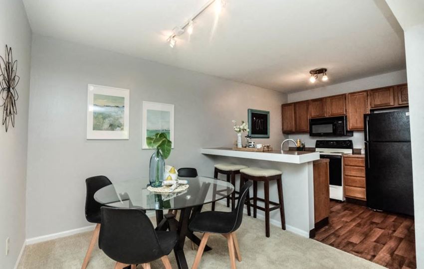 a kitchen and dining room with a table and chairs