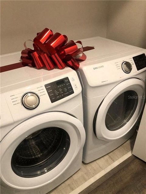 two washing machines with red bows on top of them