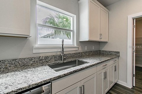 a kitchen with a sink and a window