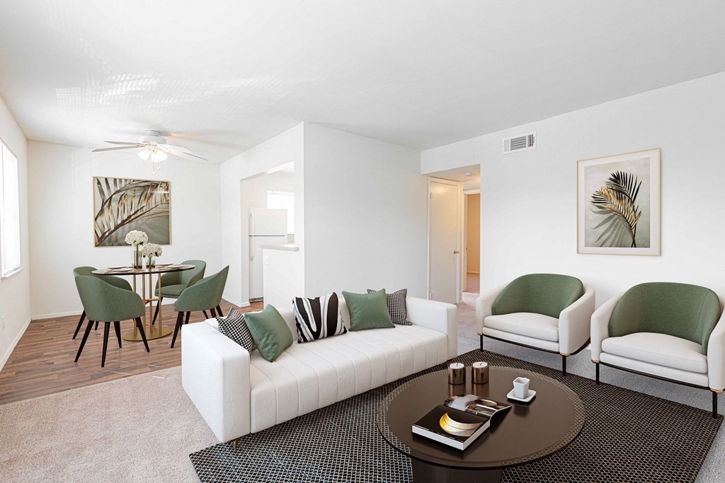 a living room with a couch and chairs and a table