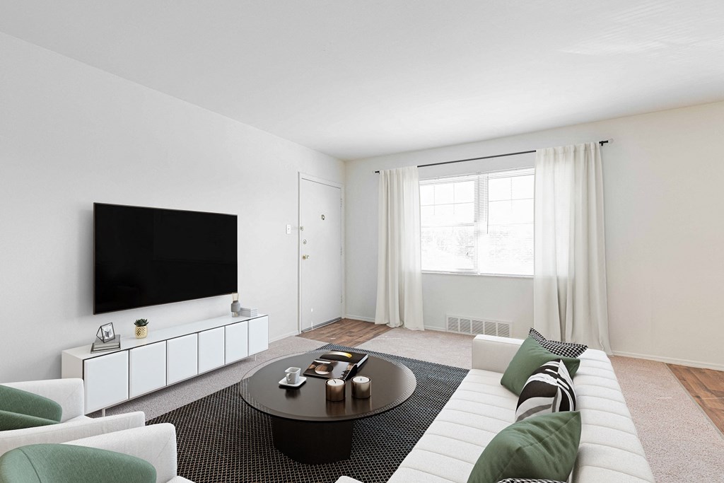 a living room with a white couch and a television