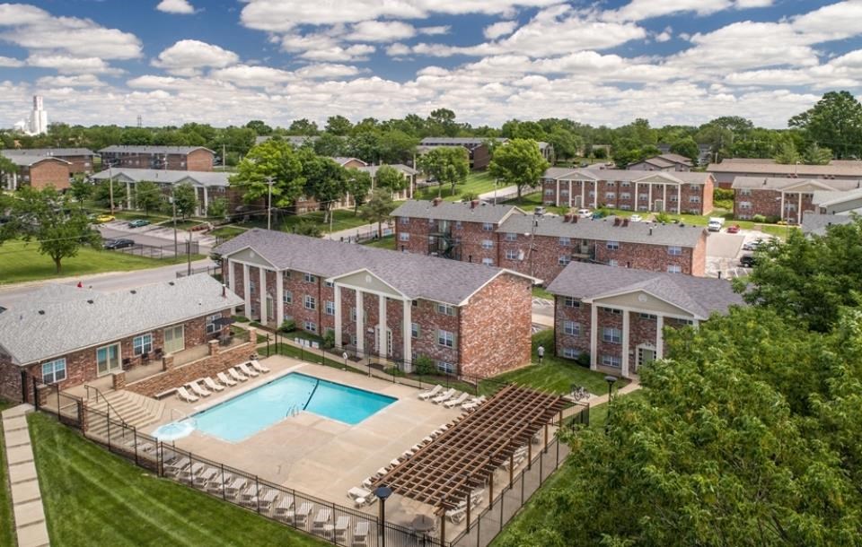 an aerial view of an apartment complex with a swimming pool