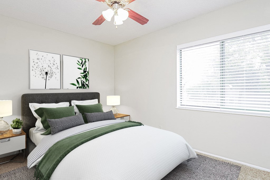 an image of a bedroom with a bed and a ceiling fan