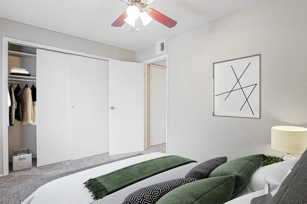 a bedroom with a bed and a ceiling fan
